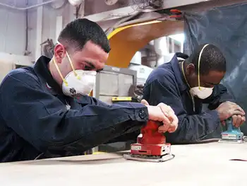 Image of two men sanding wood