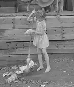Image of Young Girl Sweeping Floor